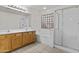 Bright bathroom featuring a double vanity, tiled floor, tub, and shower at 2171 S Portland Ave, Gilbert, AZ 85295