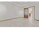 Empty bedroom with an adjacent doorway allows you to envision its potential as a flexible living space at 2171 S Portland Ave, Gilbert, AZ 85295