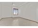 Vacant bedroom provides a blank canvas with a single window illuminating the tile flooring at 2171 S Portland Ave, Gilbert, AZ 85295