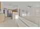 Open-concept living room features tile flooring and a ceiling fan, perfect for entertaining and relaxation at 2171 S Portland Ave, Gilbert, AZ 85295