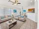 Staged living room displays modern furnishings and decor, with a partial view of the kitchen breakfast bar at 2171 S Portland Ave, Gilbert, AZ 85295