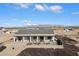 Aerial view of a single-story house with a patio, and mountain views in the background at 23527 W Estes Way, Buckeye, AZ 85326