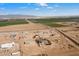 Aerial view of a new housing development in a rural setting with farmlands at 23527 W Estes Way, Buckeye, AZ 85326