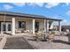 Outdoor patio with seating, string lights, and mountain views at 23527 W Estes Way, Buckeye, AZ 85326