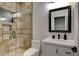 Modern bathroom with a walk-in shower and white vanity at 23527 W Estes Way, Buckeye, AZ 85326