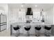 Modern kitchen island with seating and stainless steel appliances at 23527 W Estes Way, Buckeye, AZ 85326