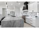 Modern kitchen with marble countertops, stainless steel appliances, and large island at 23527 W Estes Way, Buckeye, AZ 85326