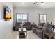 Relaxing living room features large TV and comfortable seating area with natural light at 23527 W Estes Way, Buckeye, AZ 85326