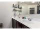 Double vanity bathroom with modern fixtures and shelving at 23802 W Tamarisk Ave, Buckeye, AZ 85326