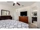 Main bedroom with ensuite bathroom access, dresser, and TV at 23802 W Tamarisk Ave, Buckeye, AZ 85326