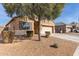 House exterior showcasing a front yard with trees and a paved driveway at 23802 W Tamarisk Ave, Buckeye, AZ 85326