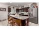 Kitchen with dark wood cabinets, granite countertops and stainless steel appliances at 23802 W Tamarisk Ave, Buckeye, AZ 85326