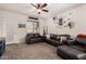 Living room with two leather sofas, an ottoman, and a ceiling fan at 23802 W Tamarisk Ave, Buckeye, AZ 85326