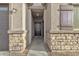 Front entry with stone accents and a dark brown door at 2562 N Abbey Rd, Casa Grande, AZ 85122