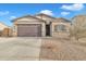 Single-story home with a two-car garage and desert landscaping at 2562 N Abbey Rd, Casa Grande, AZ 85122