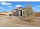 Single-story home with a two-car garage and desert landscaping at 2562 N Abbey Rd, Casa Grande, AZ 85122