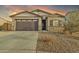 Single-story home with a two-car garage and desert landscaping at 2562 N Abbey Rd, Casa Grande, AZ 85122