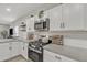 Gas range, microwave, and white cabinets in kitchen at 2562 N Abbey Rd, Casa Grande, AZ 85122