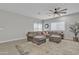 Living room with sectional sofa, large windows, ceiling fan at 2562 N Abbey Rd, Casa Grande, AZ 85122