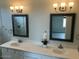 Double vanity bathroom with framed mirrors and modern light fixtures at 25835 W Denver Hills Dr, Wittmann, AZ 85361