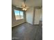 Bright bedroom with ceiling fan, double door closet, and wood-look flooring at 25835 W Denver Hills Dr, Wittmann, AZ 85361