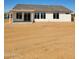 Rear view of a single-story home with sliding glass doors at 25835 W Denver Hills Dr, Wittmann, AZ 85361