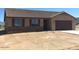 One-story home features a brown roof and stone accents at 25835 W Denver Hills Dr, Wittmann, AZ 85361