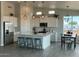 Modern kitchen with island, stainless steel appliances, and white cabinets at 25835 W Denver Hills Dr, Wittmann, AZ 85361