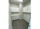 Laundry room with white cabinets and gray wood-look flooring at 25835 W Denver Hills Dr, Wittmann, AZ 85361