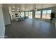 Spacious living area with an open floor plan and grey wood-look flooring at 25835 W Denver Hills Dr, Wittmann, AZ 85361