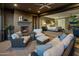 Relaxing patio with seating area and fireplace, offering views into the main bedroom at 26698 N 104Th Way, Scottsdale, AZ 85262