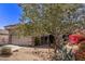 Front view of a house with a desert landscape and a two-car garage at 26818 N 66Th Ln, Phoenix, AZ 85083