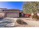 Single-story home with desert landscaping and a two-car garage at 26818 N 66Th Ln, Phoenix, AZ 85083