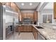 Galley-style kitchen with granite countertops and stainless steel appliances at 26818 N 66Th Ln, Phoenix, AZ 85083