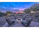 Spacious backyard with fire pit and seating area at sunset at 29308 N 132Nd Ln, Peoria, AZ 85383