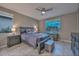 Bright bedroom with a queen-size bed and ensuite access at 29308 N 132Nd Ln, Peoria, AZ 85383