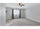 Spacious bedroom with ceiling fan and gray carpeting at 2968 E Clarendon Ave, Phoenix, AZ 85016