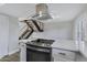 Kitchen island with cooktop and modern range hood at 2968 E Clarendon Ave, Phoenix, AZ 85016