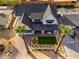 Aerial view of a beautifully landscaped home, complemented by a white fence, green grass, and palm trees at 3427 E Campbell Ave, Phoenix, AZ 85018