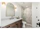 This spacious bathroom has a wood vanity and shower with grey and white tile at 3427 E Campbell Ave, Phoenix, AZ 85018