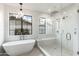 This bright bathroom features a glass shower with a bench and a freestanding tub at 3427 E Campbell Ave, Phoenix, AZ 85018