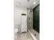 This stylish bathroom features an emerald green shower and a vanity cabinet for storage at 3427 E Campbell Ave, Phoenix, AZ 85018