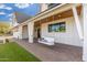 This covered porch has a porch swing for relaxing and beautiful brick flooring at 3427 E Campbell Ave, Phoenix, AZ 85018