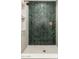 Spa-like shower with herringbone patterned tile in dark green at 3427 E Campbell Ave, Phoenix, AZ 85018