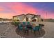 Backyard with firepit and seating under sunset sky at 34709 N 48Th St, Cave Creek, AZ 85331