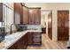 Modern kitchen with granite countertops and dark wood cabinets at 34709 N 48Th St, Cave Creek, AZ 85331