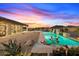 Long rectangular pool with a water feature, surrounded by desert landscaping at 34709 N 48Th St, Cave Creek, AZ 85331