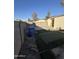 Backyard with artificial turf, block wall, and trash bin at 3646 N 69Th Ave # 55, Phoenix, AZ 85033