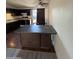 Kitchen with dark brown cabinets and a kitchen island at 3646 N 69Th Ave # 55, Phoenix, AZ 85033