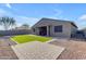 Landscaped backyard featuring artificial grass and patio at 37029 N Andravida Dr, San Tan Valley, AZ 85140